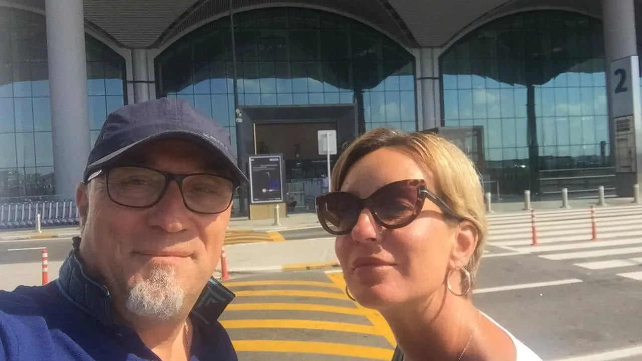 Passengers outside an airport terminal